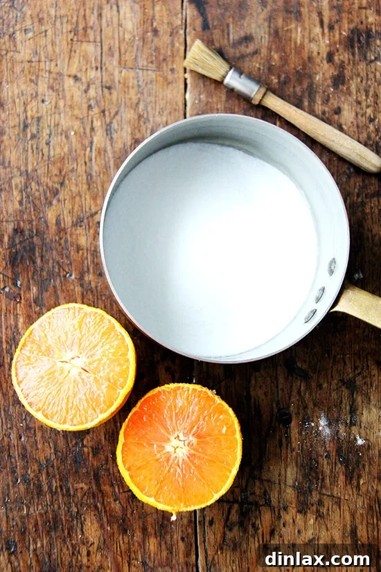 Mastering Chocolate Swirl Babka 10 A small saucepan containing the ingredients for the zesty orange syrup, sugar and fresh orange juice, simmering gently.