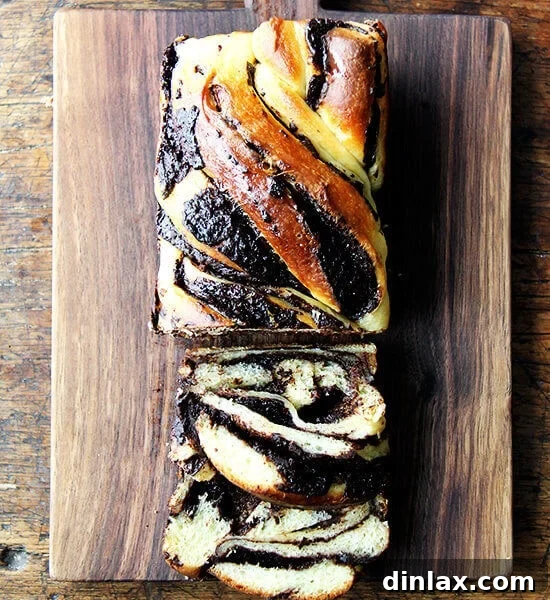 A board of orange-chocolate babka, showcasing its delightful swirls and golden glaze.