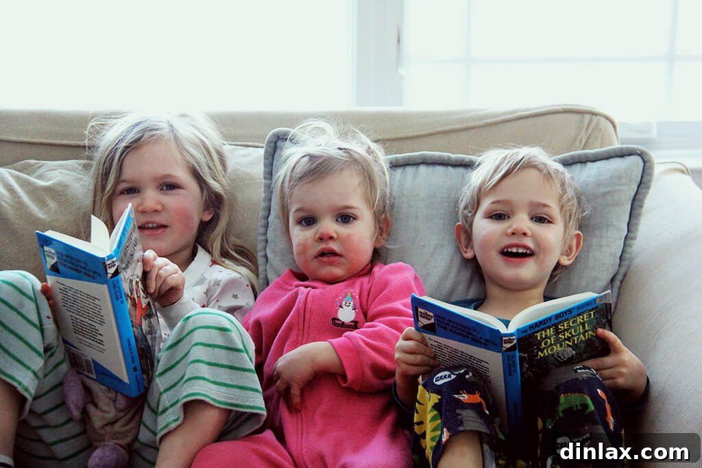 Two children enjoying a meal, likely at a restaurant, looking happy and engaged.