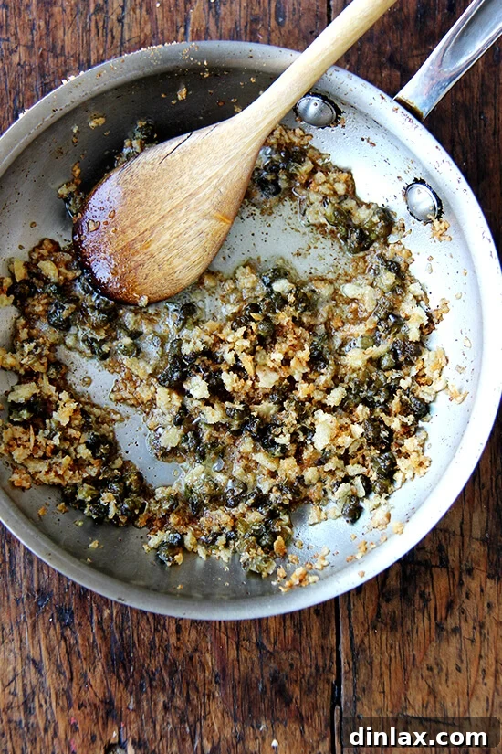 Homemade breadcrumbs tossed in browned butter with crispy capers, creating a fragrant topping.