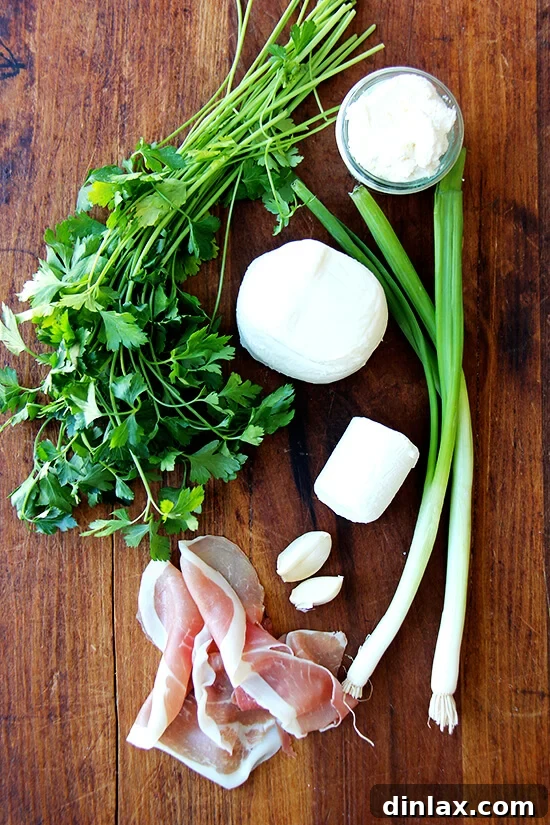 Essential filling ingredients for the calzones: fresh parsley, creamy goat cheese, pungent garlic, shredded mozzarella, vibrant scallions, and savory prosciutto.