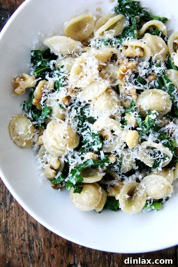 A vibrant bowl of Orecchiette pasta tossed with tender Swiss chard, rich brown butter, and crunchy walnuts, ready to be enjoyed.