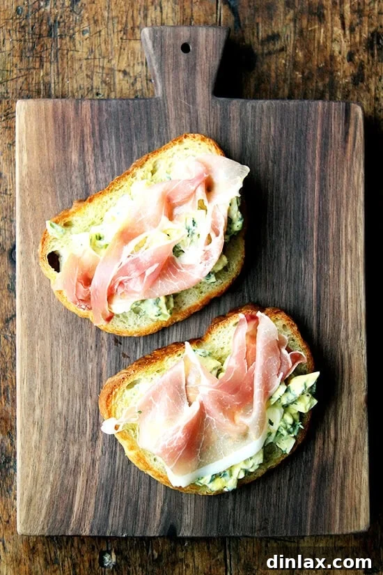 Briny Egg Salad Crostini 2 Beautifully plated pickled egg salad on toast, garnished, highlighting its appetizing appearance and texture. The vibrant colors suggest fresh ingredients and a delightful tang.