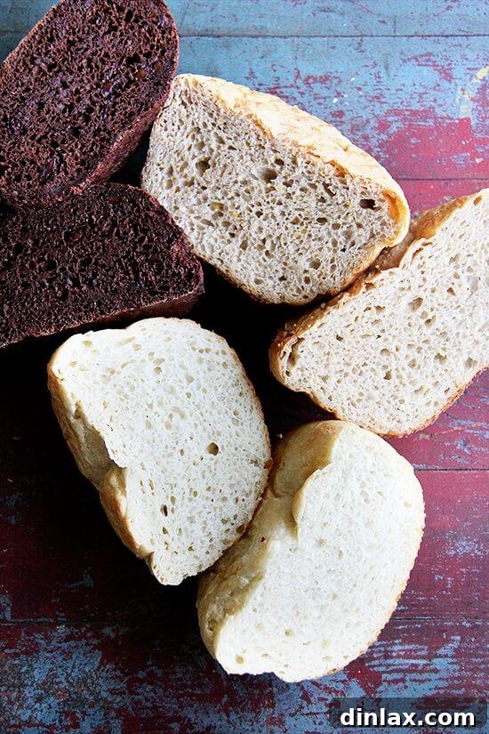 A detailed view of the interior of a halved peasant bread, highlighting its signature open crumb structure, perfect for absorbing butter or olive oil.