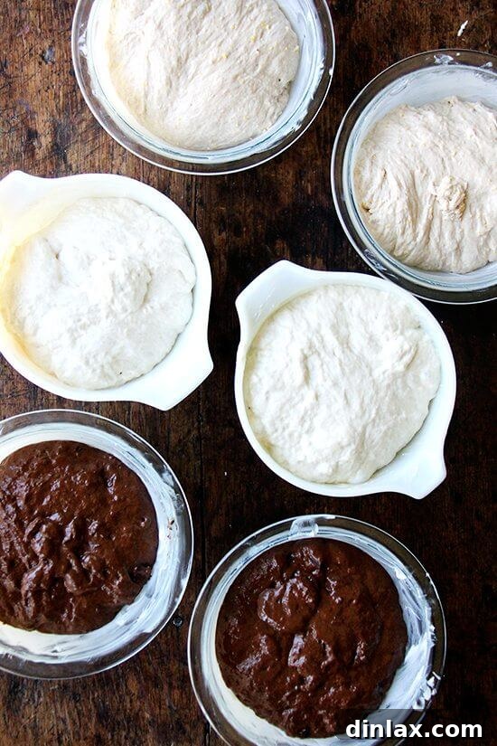 The Book's Revelation 3 Three glass bowls of peasant bread dough rising; from top to bottom: whole wheat with cornmeal, the classic master peasant bread recipe, and a rich dark chocolate with coffee variation.