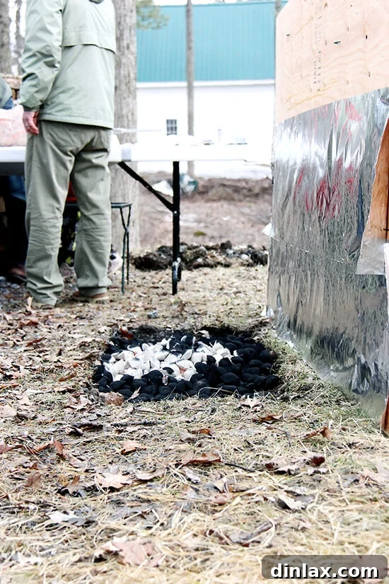 Uncle Wade and family carefully preparing the coals for a traditional Greek Easter lamb roast, ensuring perfect heat for spit-roasting.