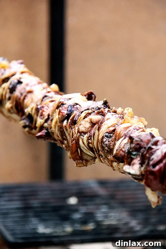 The savory kokoretsi, perfectly roasted and golden, a highlight of the Greek Easter culinary spread.