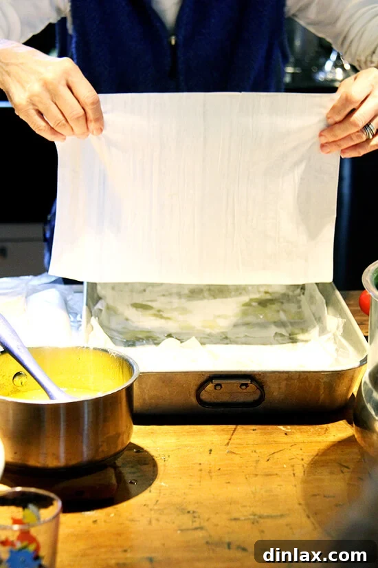 Marcy skillfully kneading and shaping dough to create homemade pita bread, a delicious addition to the feast.