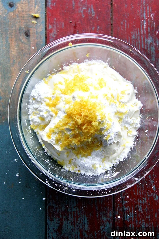 Close-up of fresh lemon zest being grated, highlighting its vibrant aroma.