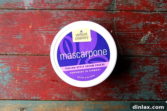 A tub of high-quality mascarpone cheese, ready for the filling.