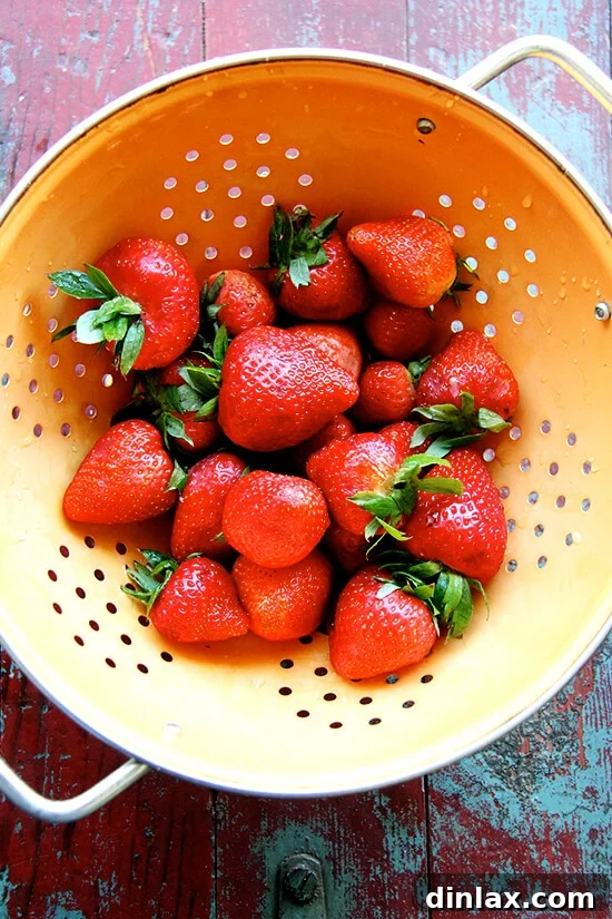 Fresh, ripe strawberries, stemmed and ready for topping the tart.