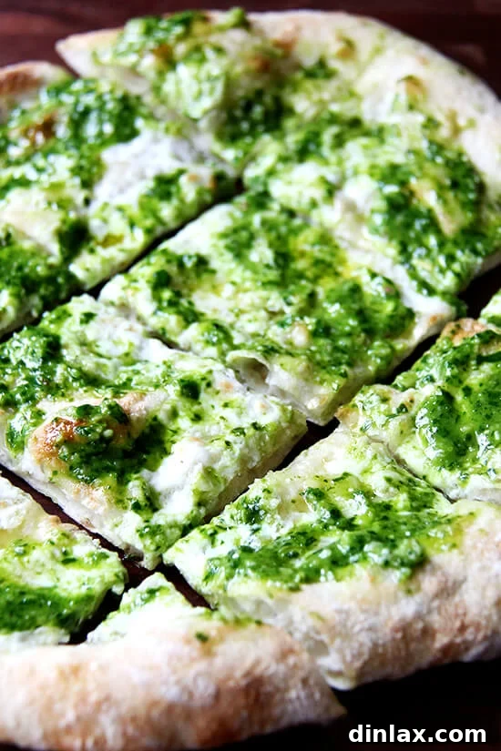 Ramp Pesto Pizza and Pickled Ramps 11 Close-up of a ramp pesto pizza, showing the creamy burrata and vibrant green pesto.