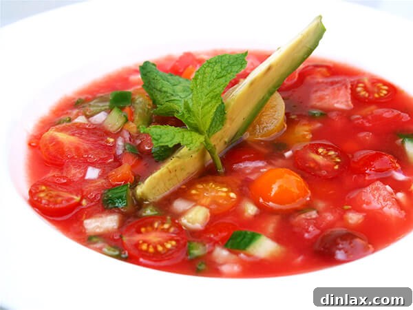A vibrant bowl of chilled watermelon gazpacho, a refreshing and unique summer starter.