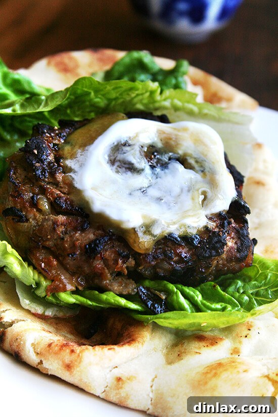 Delicious curried lamburgers topped with chutney mustard and a dollop of Greek yogurt, a gourmet burger alternative.