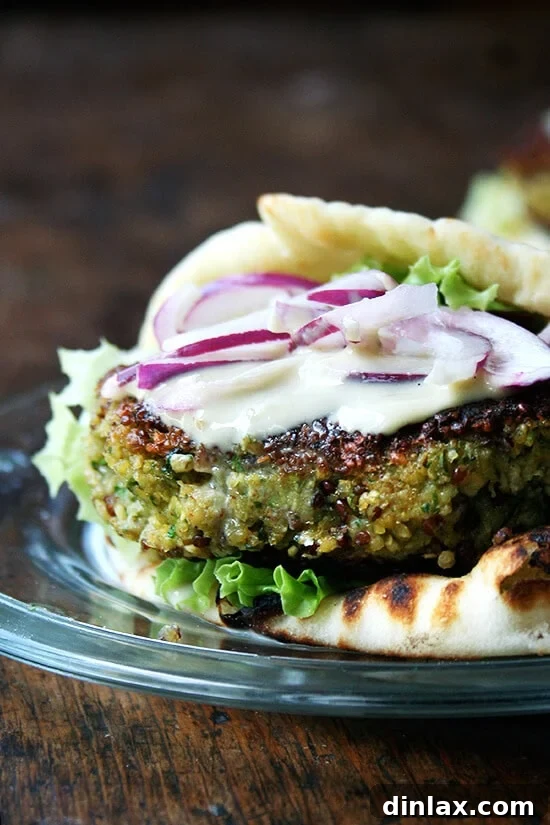 Hearty and flavorful falafel-style veggie burgers made with chickpeas, quinoa, and zucchini, served with tahini sauce.