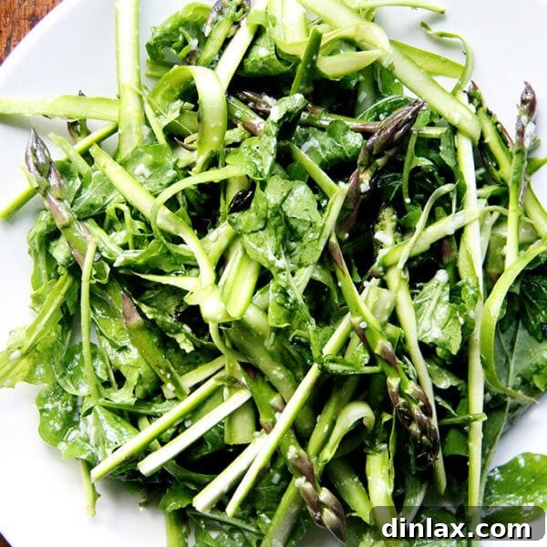 A beautifully presented raw asparagus salad, vibrant and fresh.