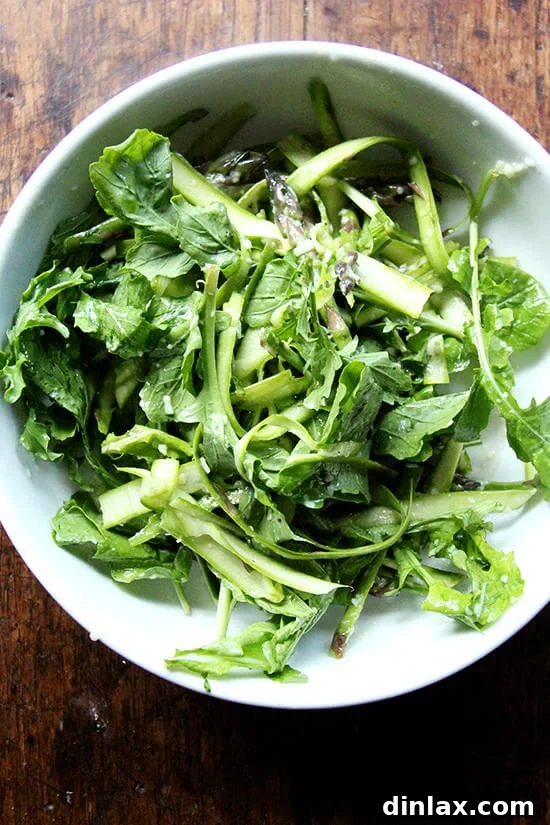 Canal House Spring Shaved Asparagus and Arugula Salad 10 A vibrant shaved asparagus and arugula salad in a large serving bowl.