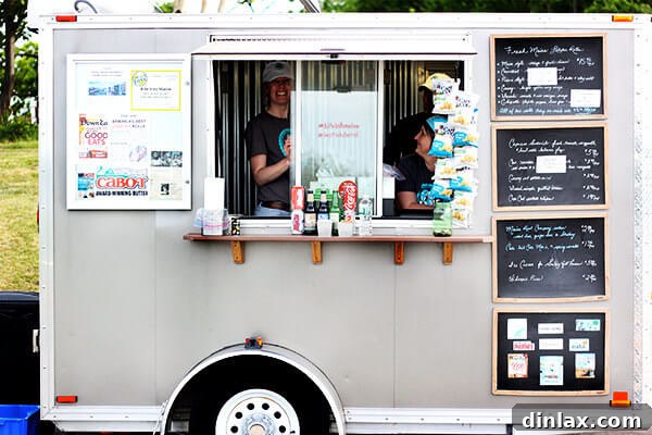 Close-up of the Bite Into Maine food truck, highlighting its offerings in a scenic park setting.