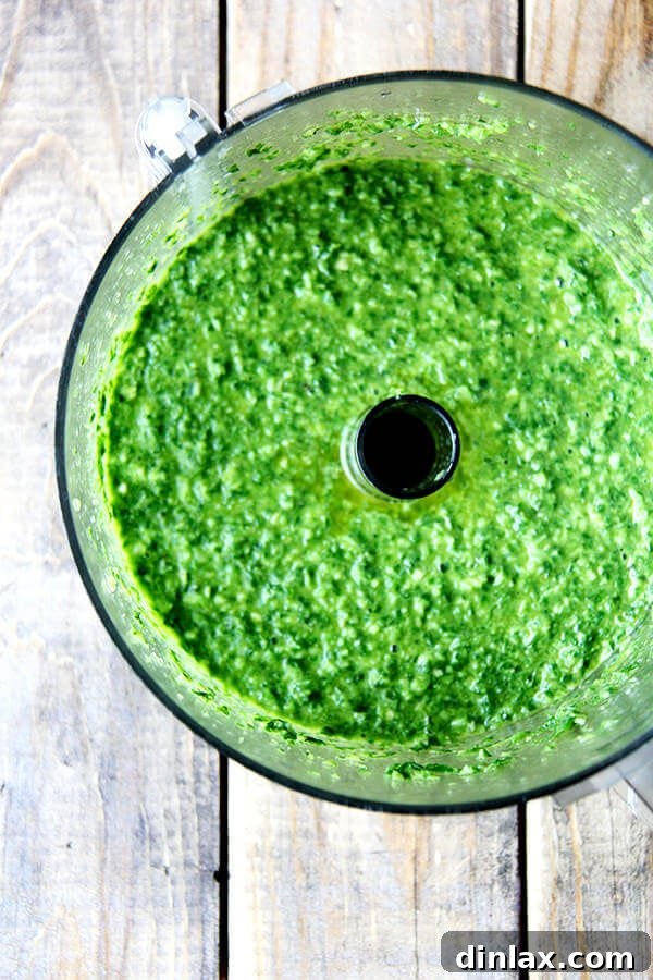 Pureed green harissa sauce in a food processor