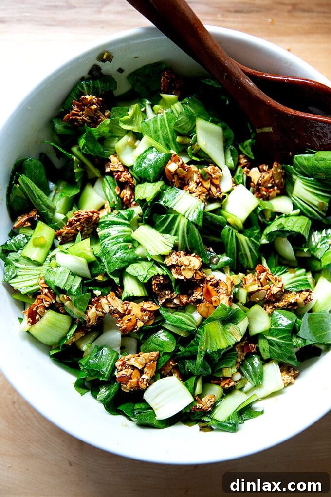 Freshly prepared raw bok choy salad, showcasing vibrant green leaves and crunchy stalks.