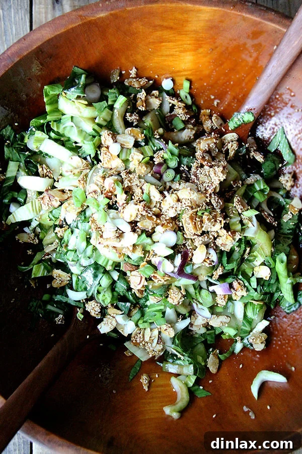 A generously sized salad bowl overflowing with the complete bok choy salad, dressed and ready.
