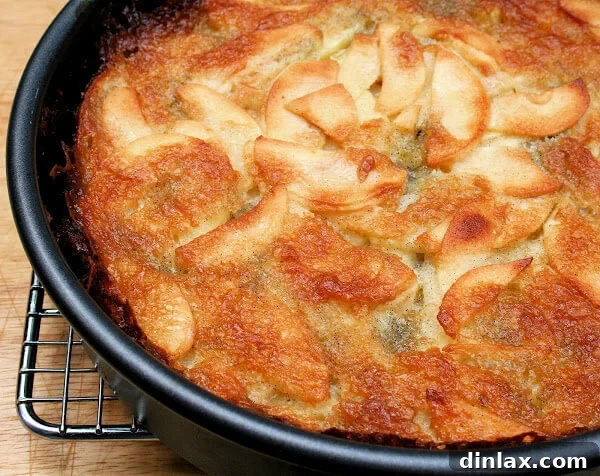 A close-up of the Bolzano apple cake batter, generously mixed with thinly sliced apples.