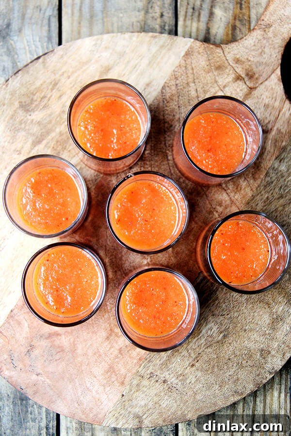 Glasses with a base of peach purée, ready for Prosecco