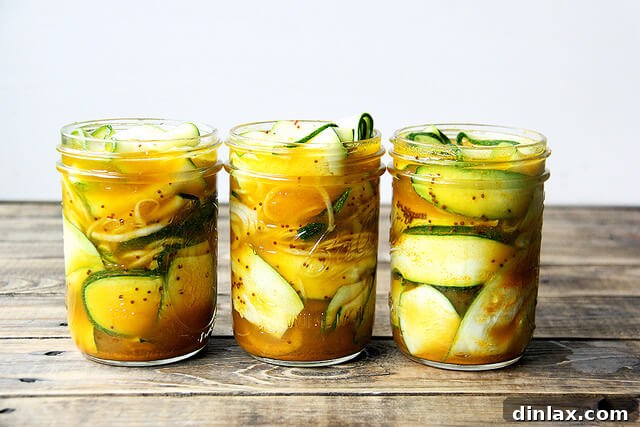 Week 4 CSA: Buttermilk Bliss, Green Revival, and Pickled Perfection 6 A neatly arranged plate of various zucchini pickles, showcasing different shapes and sizes, perhaps with some herbs or spices visible in the brine.