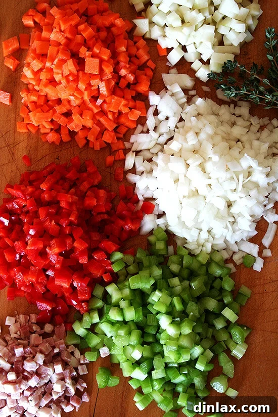 A selection of fresh ingredients prepared for Vermont Cheddar Cheese Soup, demonstrating the 'mise en place' technique for efficient cooking.