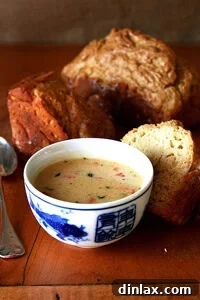 Rich Vermont Cheddar Cheese Soup, garnished with crispy pancetta, a perfect comfort meal.