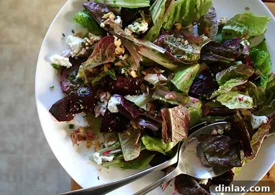 A vibrant and colorful salt-roasted beet salad, exquisitely plated with creamy goat cheese crumbles and crunchy toasted walnuts, a healthy and flavorful side dish.