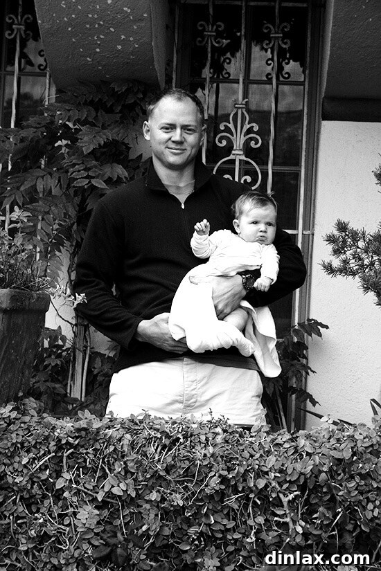 A heartwarming photograph of Ben and Rebeka, a couple and their child, smiling warmly during their stay at Buky House, capturing a sweet travel memory.