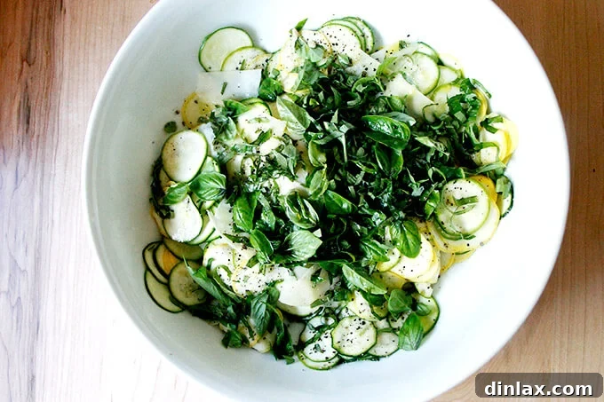 Close-up of raw zucchini ribbons in a bowl, ready for dressing.