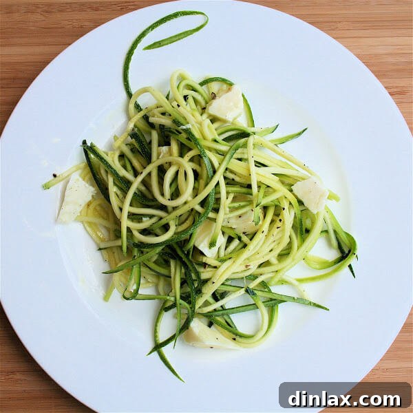 A close-up shot of the raw zucchini salad, highlighting the fresh ingredients and elegant presentation.