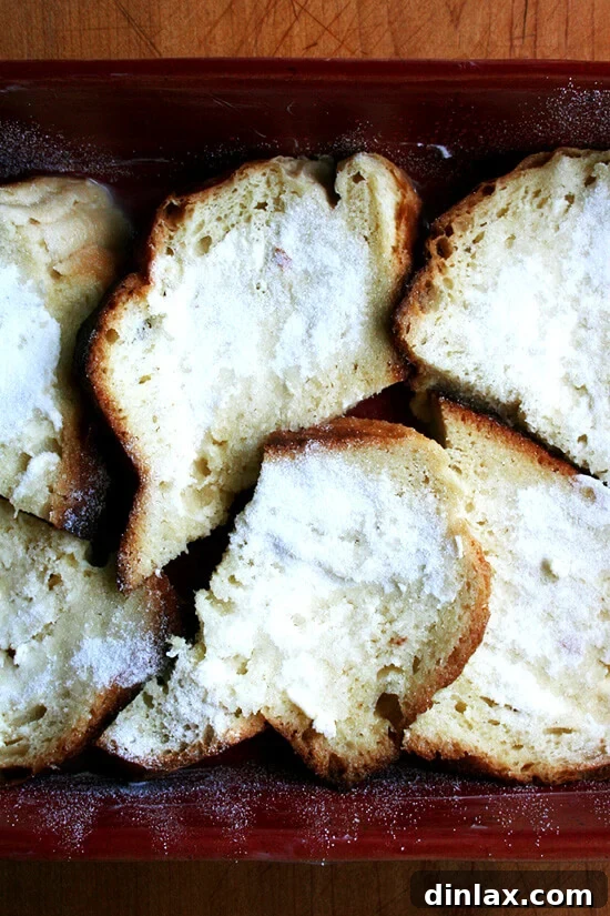Unbaked French Toast casserole dish after soaking overnight, showing bread saturated with custard.