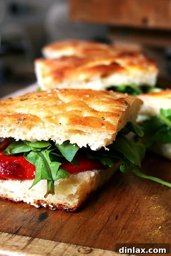 A close-up view of the delectable Roasted Red Pepper and Arugula Sandwich on Homemade Focaccia, highlighting its layers