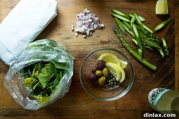 Assorted fresh ingredients for fish en papillote laid out on a wooden cutting board, showcasing variety and freshness.