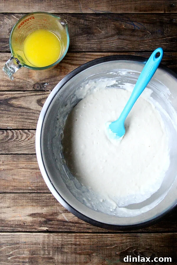 adding the melted butter to the pancake batter