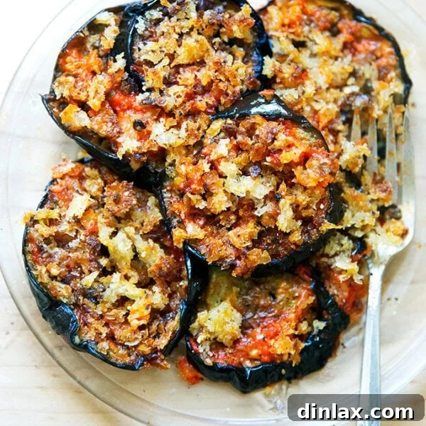 A plate of baked eggplant parmesan, ready to be served.