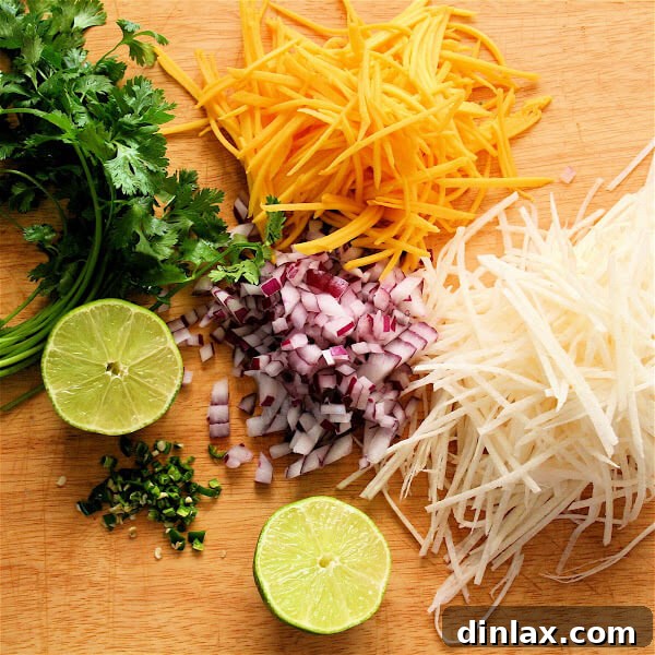 Frozen halibut steaks fried beautifully for these fish tacos, served with a sriracha-sour cream and vibrant mango-jicama slaw. A delightful culinary creation for seafood lovers.