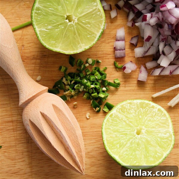Close-up of a rustic wooden reamer, used for extracting juice from citrus fruits like limes.
