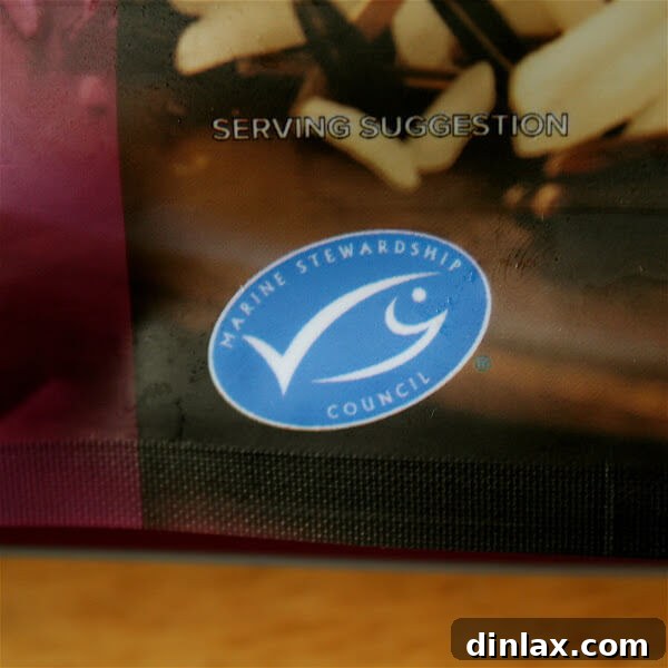 A small bowl containing creamy sriracha-sour cream, garnished with a sprinkle of red pepper flakes.