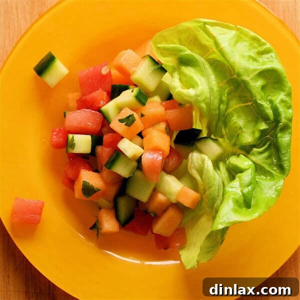 Summer Melon Cucumber Delight 5 A beautifully composed serving of melon and cucumber salad with fresh mint leaves as garnish, showcasing its refreshing appeal.