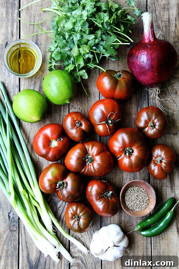 A rustic wooden board displaying fresh ingredients for salsa fresca, including tomatoes, onions, garlic, and cilantro.