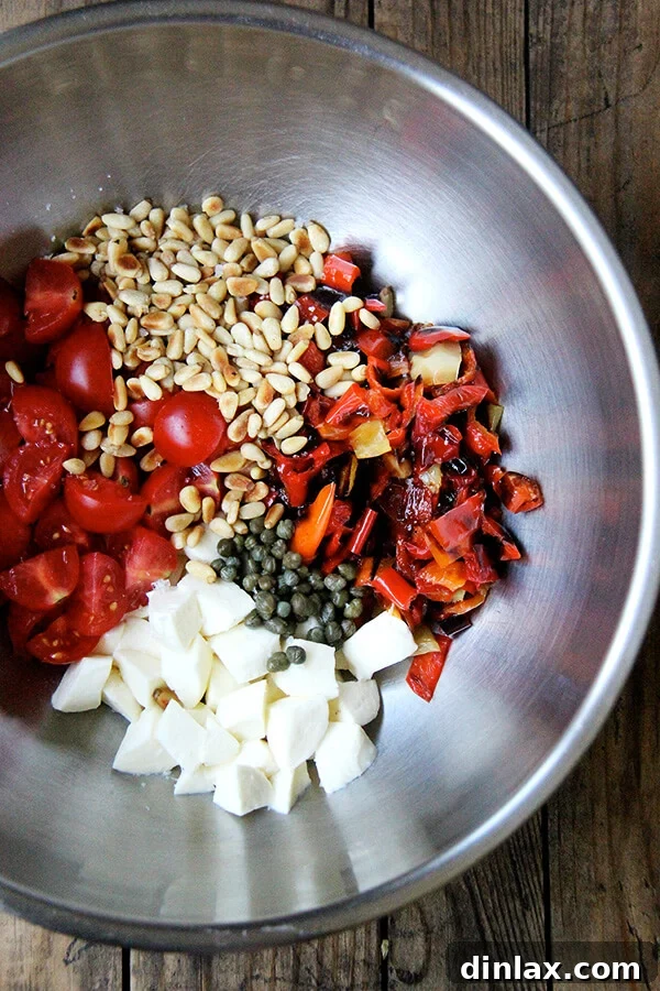 Gathering the goods: A beautiful array of fresh ingredients—tomatoes, mozzarella, capers, pine nuts, and herbs—laid out, poised to elevate the "Magic Peppers" into a full-fledged, delicious salad. A curated selection of fresh salad ingredients—cherry tomatoes, mozzarella, capers, pine nuts, and herbs—ready to be tossed with the prepared 'Magic Peppers' for a vibrant salad.