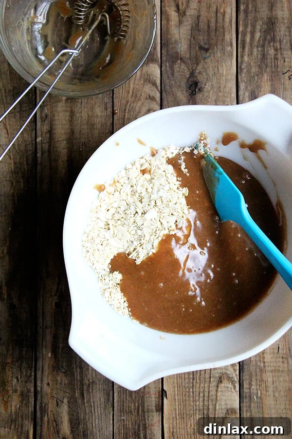 Homemade Granola Bars for Back-to-School 10 Mixing the dry and wet ingredients to create the granola bar mixture.