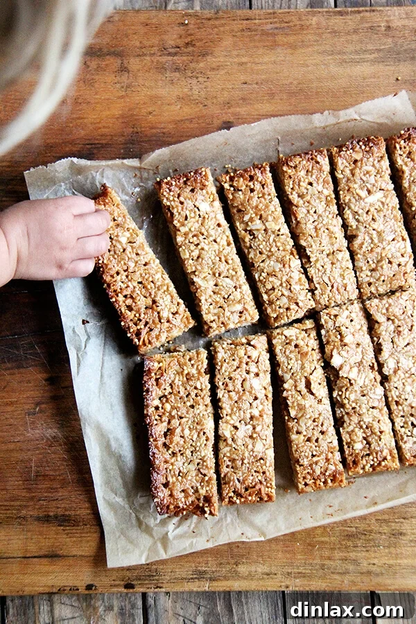 Delicious & Easy Coconut-Almond Granola Bars Close-up of baked coconut almond granola bars, showcasing their texture and ingredients. A perfect healthy lunchbox idea. // alexandracooks.com