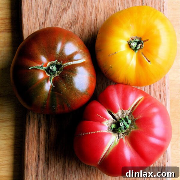 Vibrant Caprese Salad: A celebration of fresh heirloom tomatoes, creamy buffalo mozzarella, and fragrant basil leaves, drizzled with olive oil.