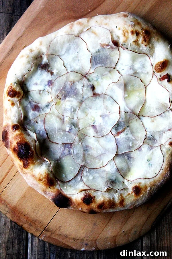 The paper-thin potatoes on this potato pizza require no pre-cooking, and a drizzle of olive oil and sea salt overtop renders additional cheese unnecessary. This has to be one of my all-time favorite pizzas (feeling bold!) though I have no doubt the fresh potatoes play a role here. Also bacon. And crème fraîche. // alexandracooks.com