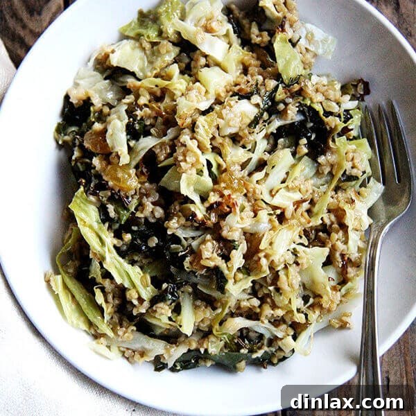 A top-down shot of the vibrant Freekeh Salad with roasted kale and cabbage in a white bowl, ready to be served.